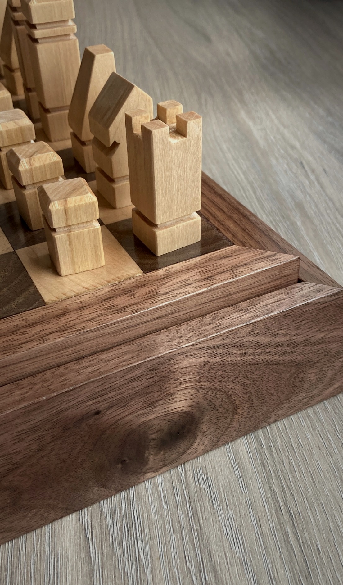 Detail of the walnut storage base and linden chess pieces